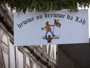 Every neighborhood has thrown up benches, maybe laid on a band, for open town welcome on the night before the 3-day Grenzgang festival. The "Hewwe on drewwe da Laeh" neighborhood sign.