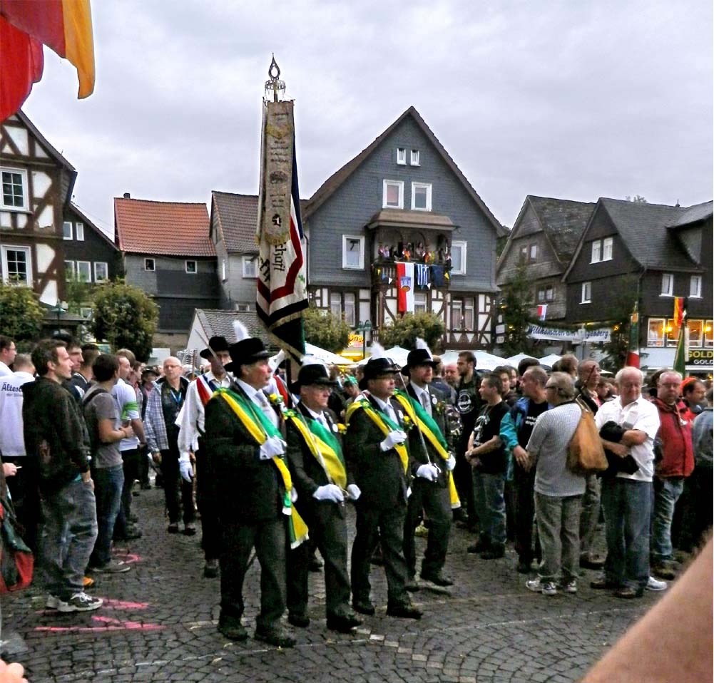 Grenzgang Biedenkopf - a Maennergesellschaft in green & white sashes.